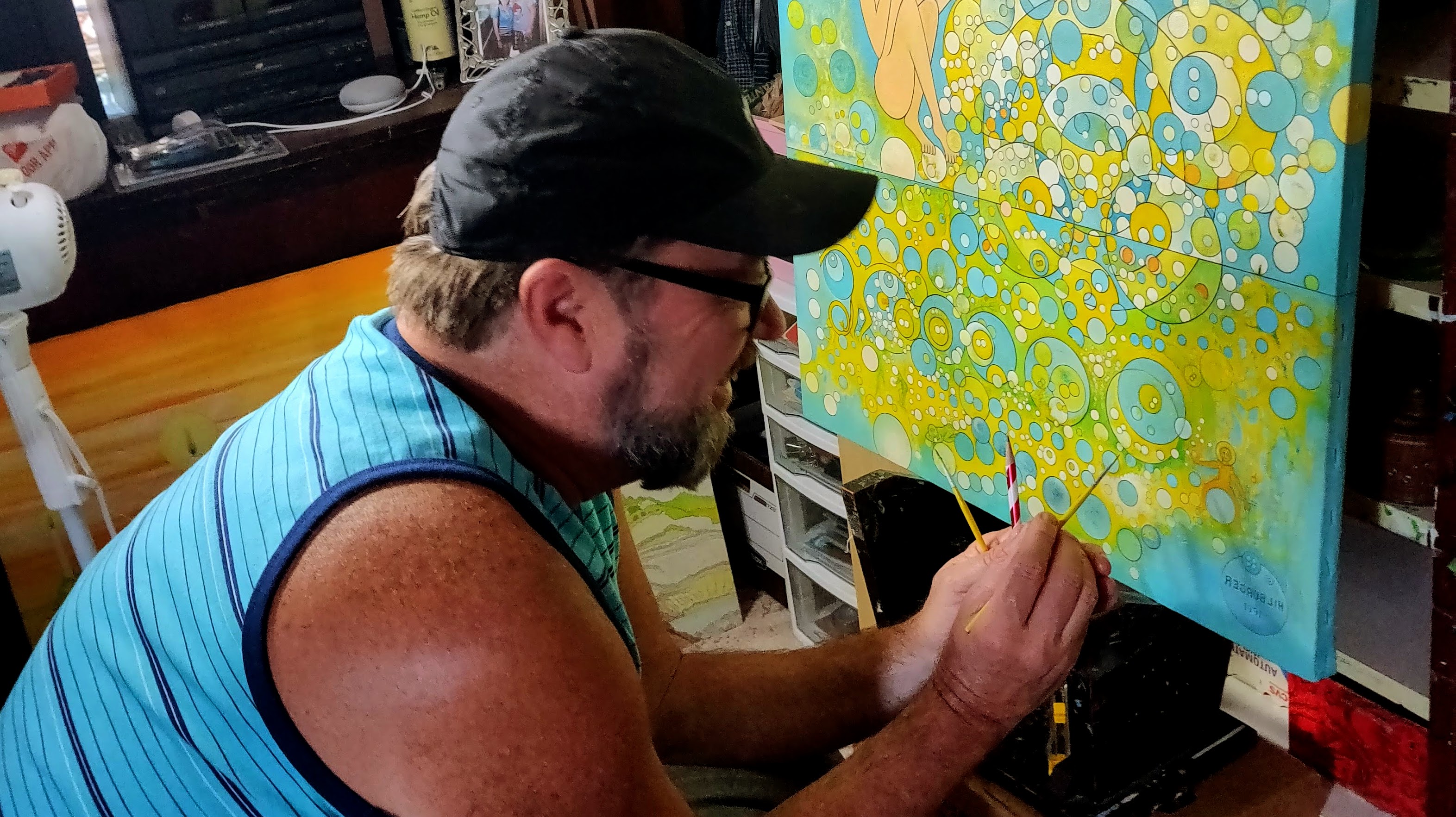 Larry doing touch-up work on Forever Blowing Bubbles in 2019, almost three decades after he painted it