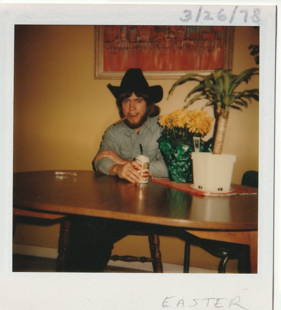 Larry on Easter with a cowboy hat, beer and cigar at the family home, 1978