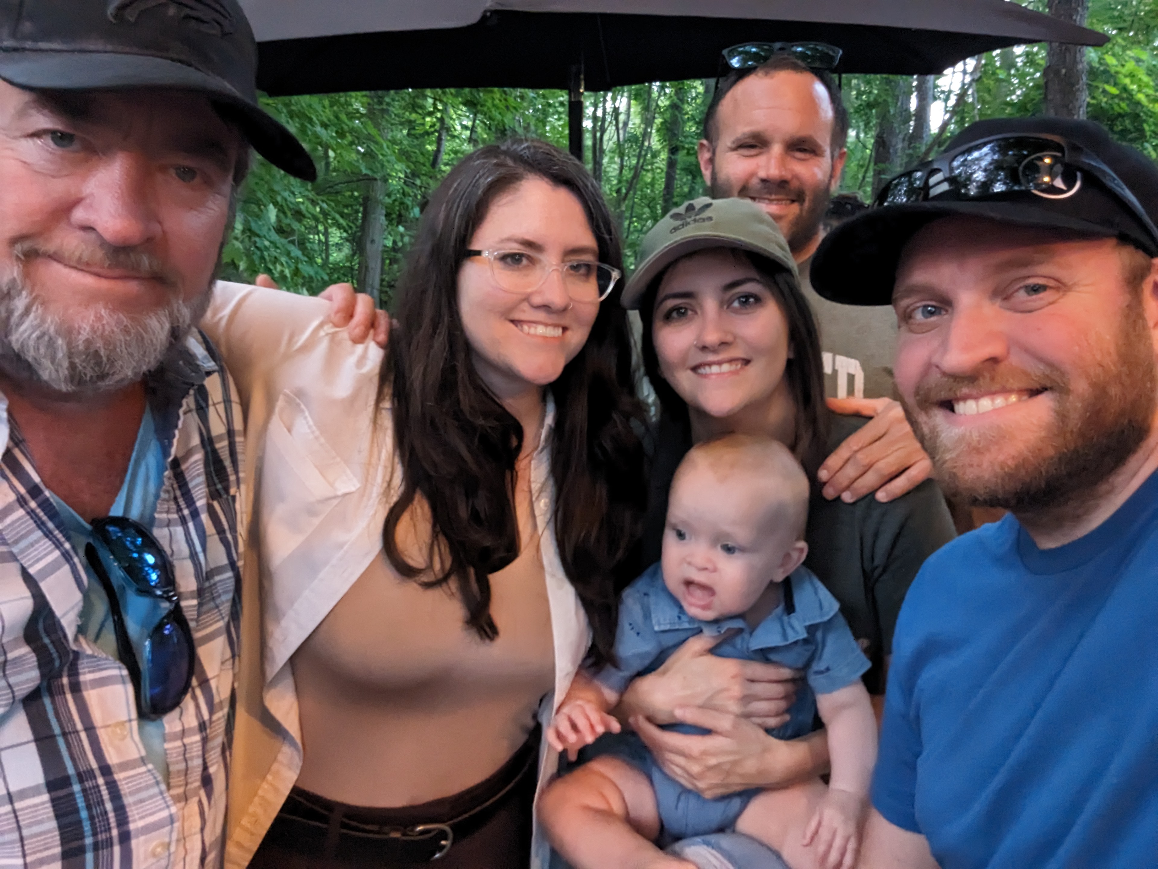 Family selfie under a tent. Larry, Christina, Kim, baby Nova and family, 2023