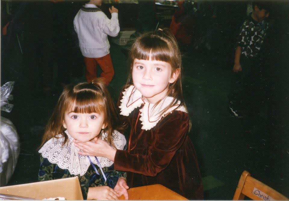 Christina and Kim in maroon velvet dresses with lace collars at a Brocton School Thanksgiving event, mid-1990s