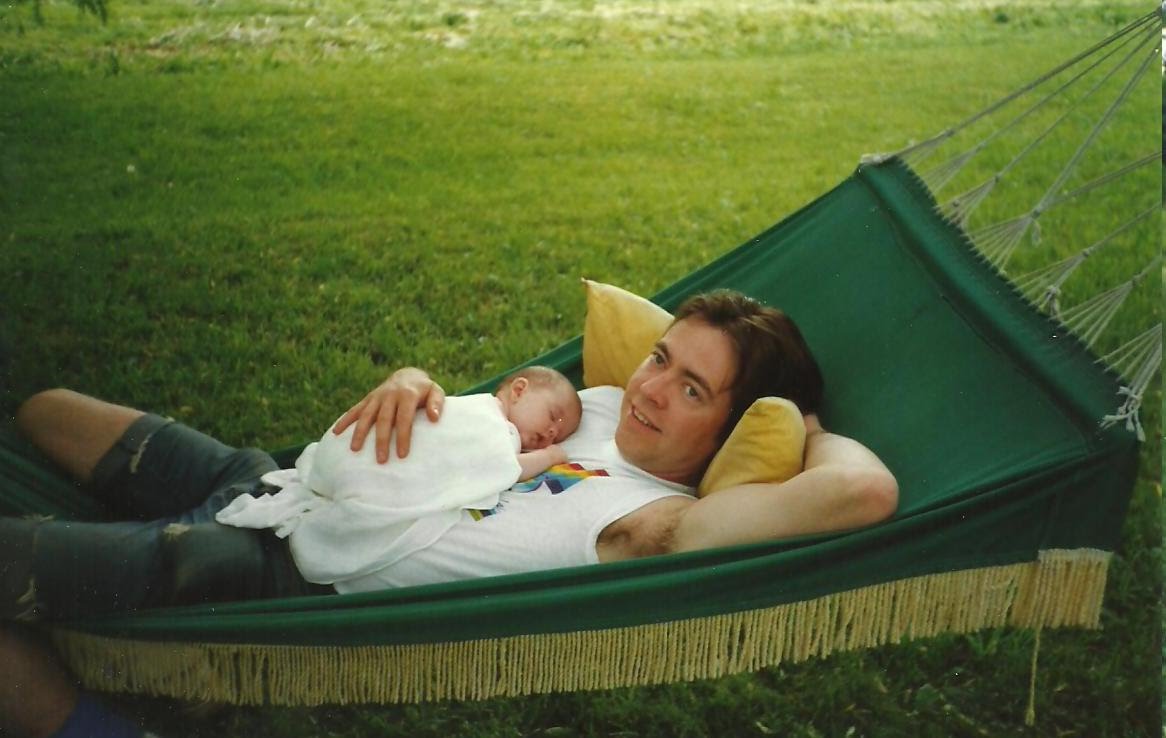 Larry on a green hammock with a sleeping newborn Christina on his chest, 1991