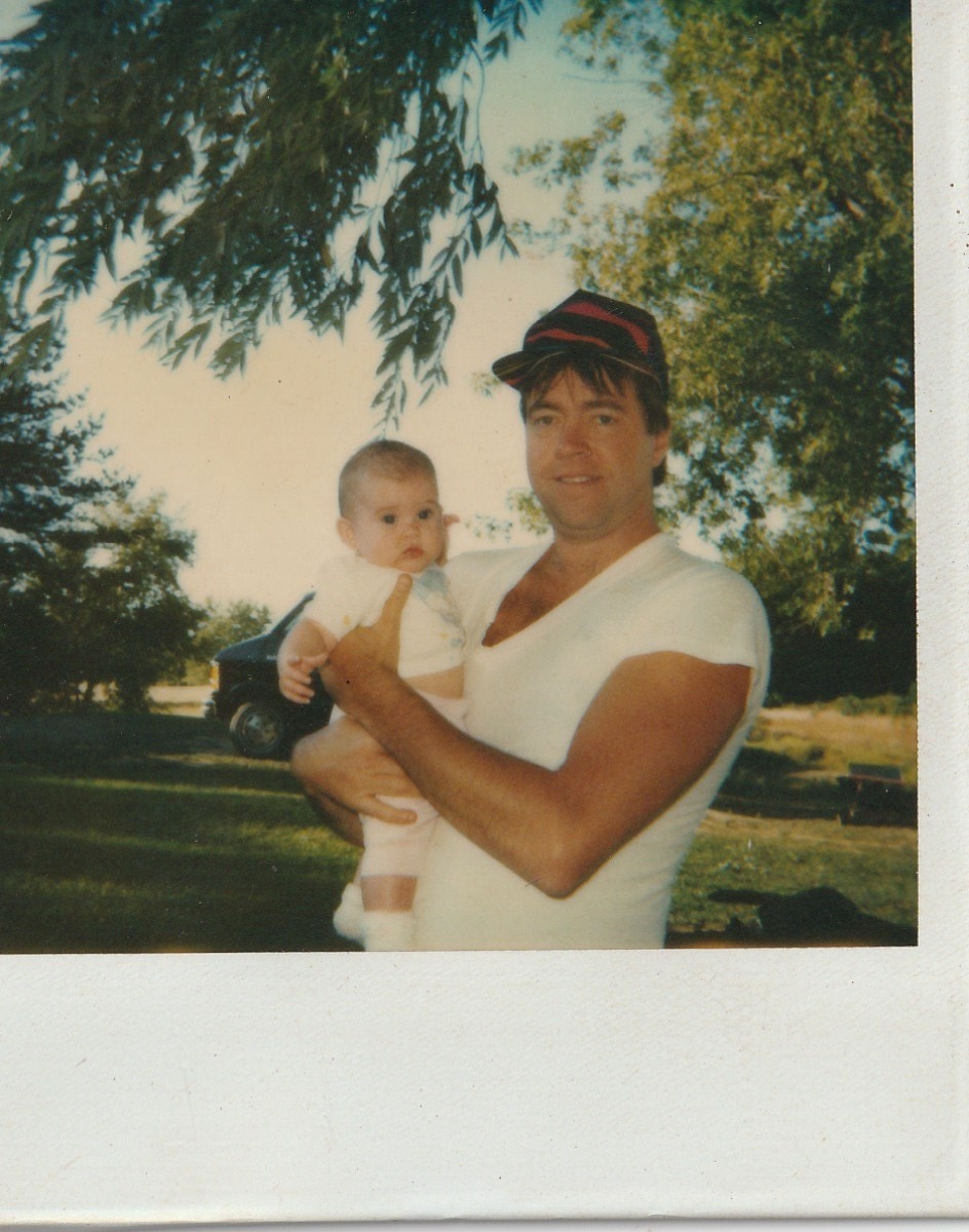 Larry holding baby Christina outdoors, summer 1991