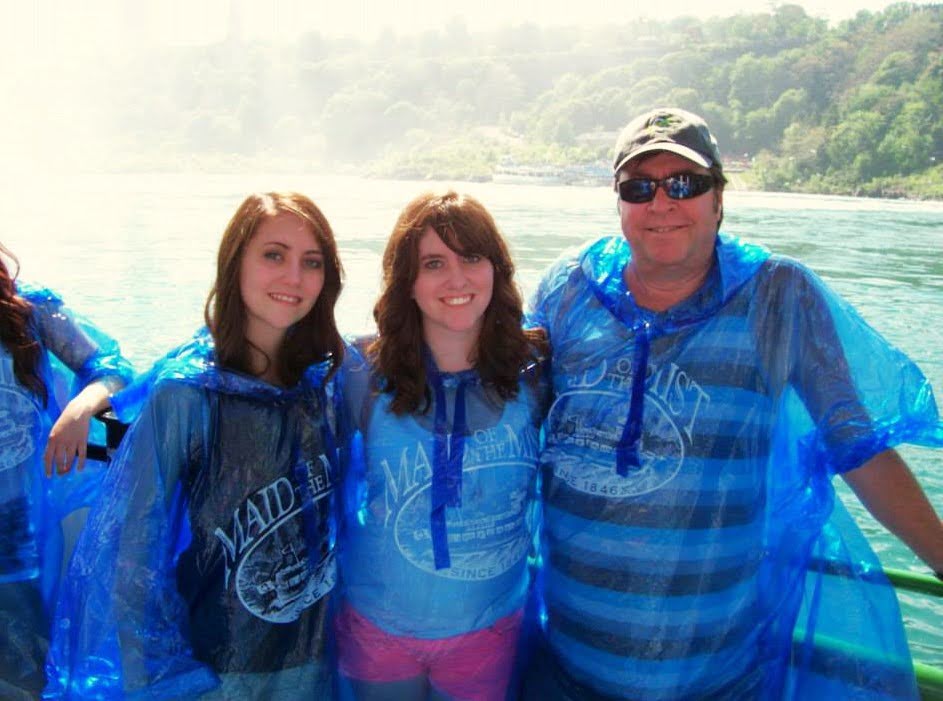 Larry with his daughters Christina and Kim on the Maid of the Mist boat at Niagara Falls in blue ponchos, 2017