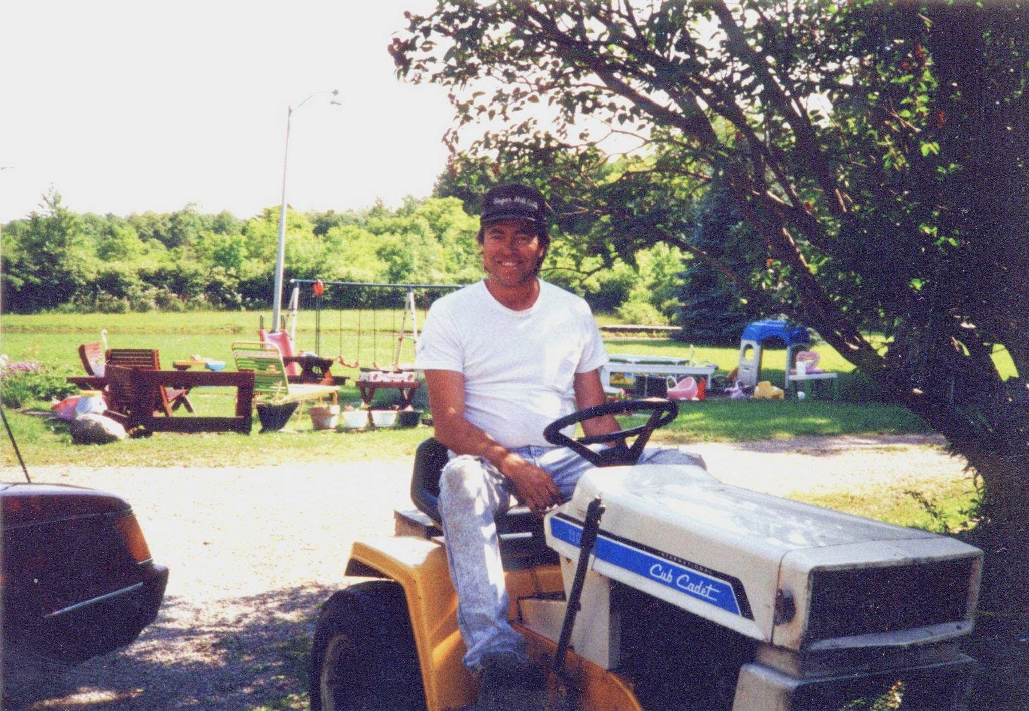 Larry on his Cub Cadet riding mower at the Westfield farm, early 1990s
