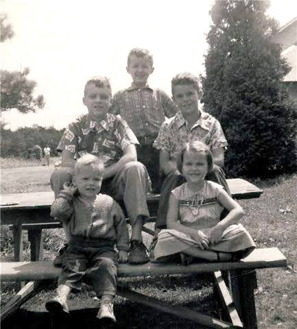 Larry with his siblings on a picnic table at Point Breeze