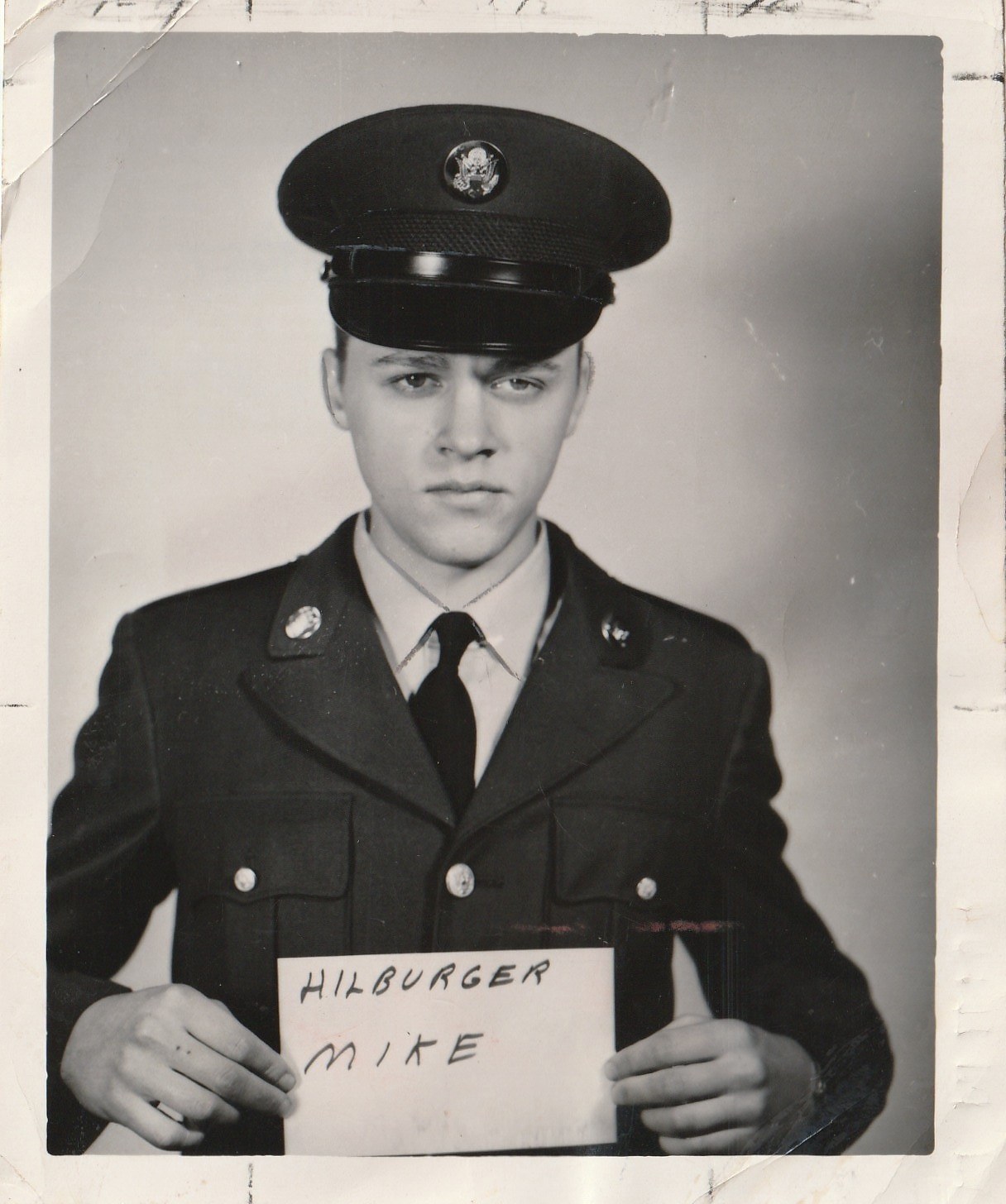 Mike's official Army portrait, holding a card with his name