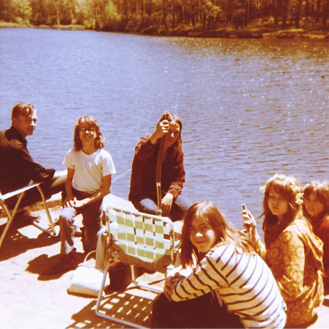 Larry and family by a lake at Allegany State Park, 1972