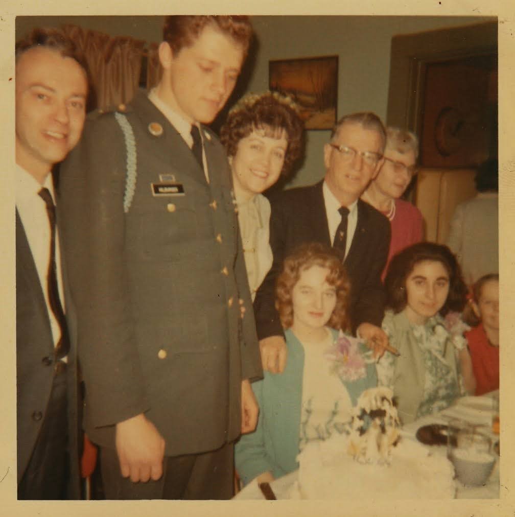 Family gathered around Mike on his Army leave