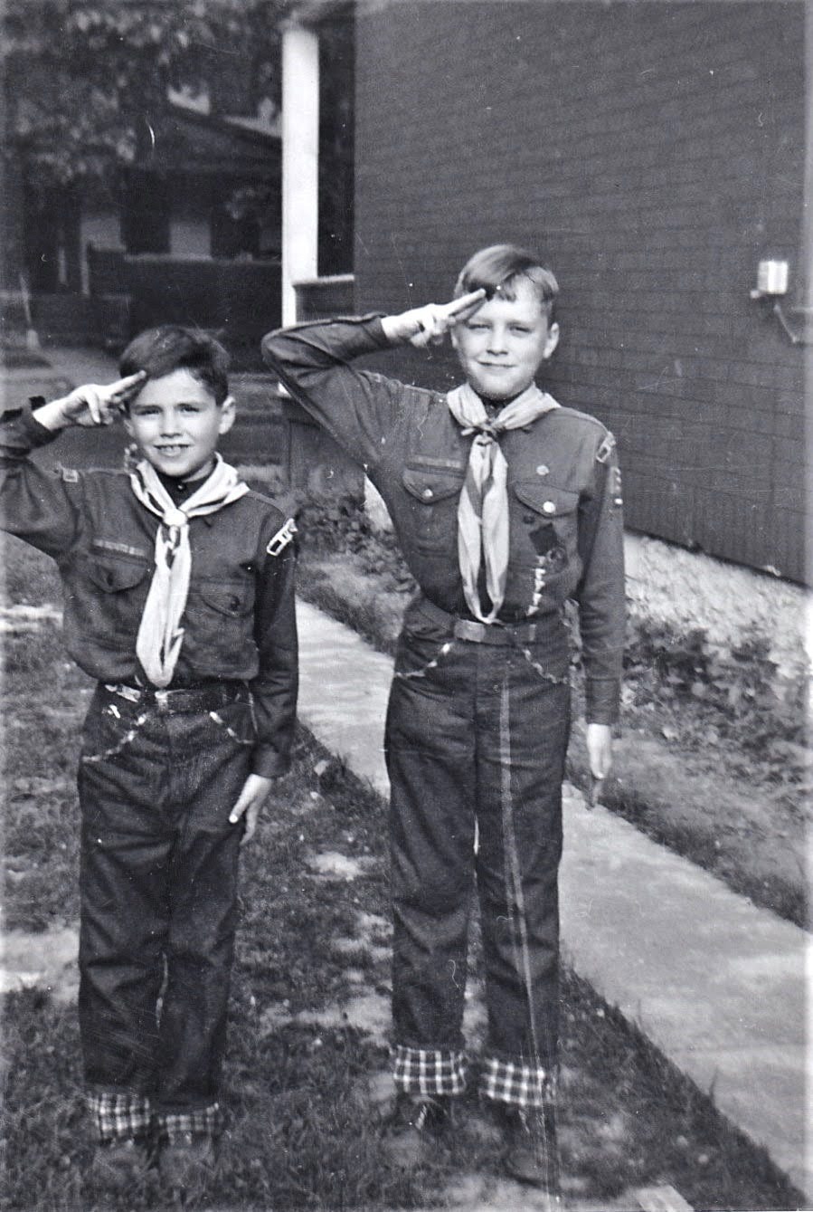 Mike and Rick saluting in their Scout uniforms