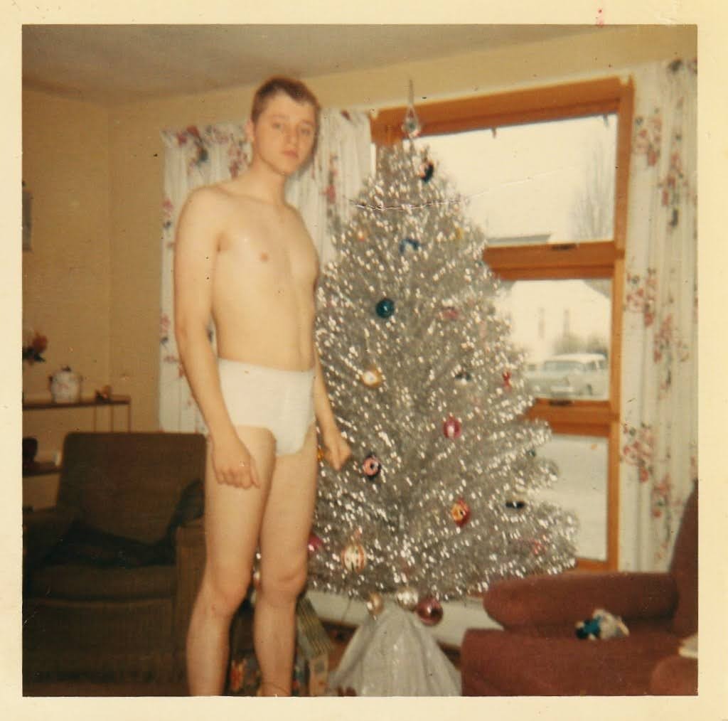 Mike posing next to the silver aluminum Christmas tree