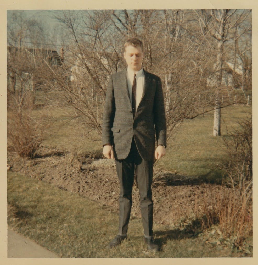 Mike in a tweed jacket and tie on the family lawn