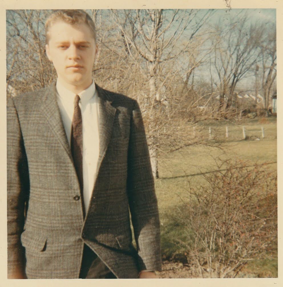 Mike in a jacket and tie outdoors